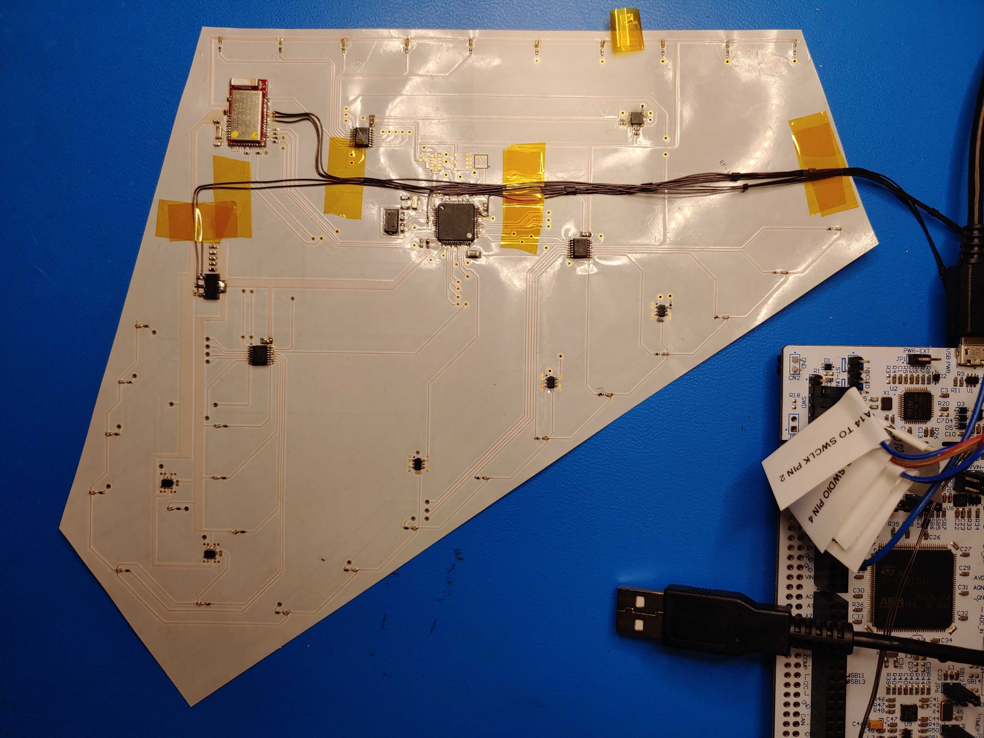 <b>Bat Bot Wing</b><p><em>I soldered each component onto the flexible membrane PCB, designed to also serve as the
           wing of the Bat Bot. Having not had prior experience soldering components this small, I did extensive online research and watched several training videos. I then programmed the STM32
           processor in C to send commands to the sensors and drivers over an SPI interface.</em></p>